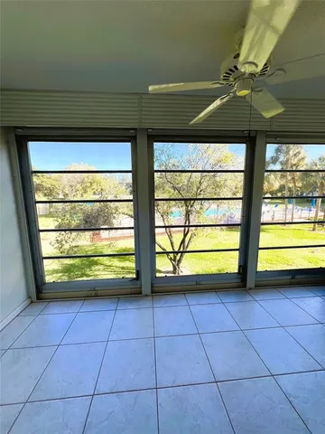 a view of a room with window and a ceiling fan