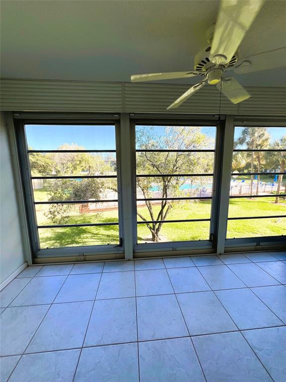 1803 Eleuthera Point, Unit J2 Coconut Creek, FL 33066 - Photo 5 of 27 a view of a room with window and a ceiling fan