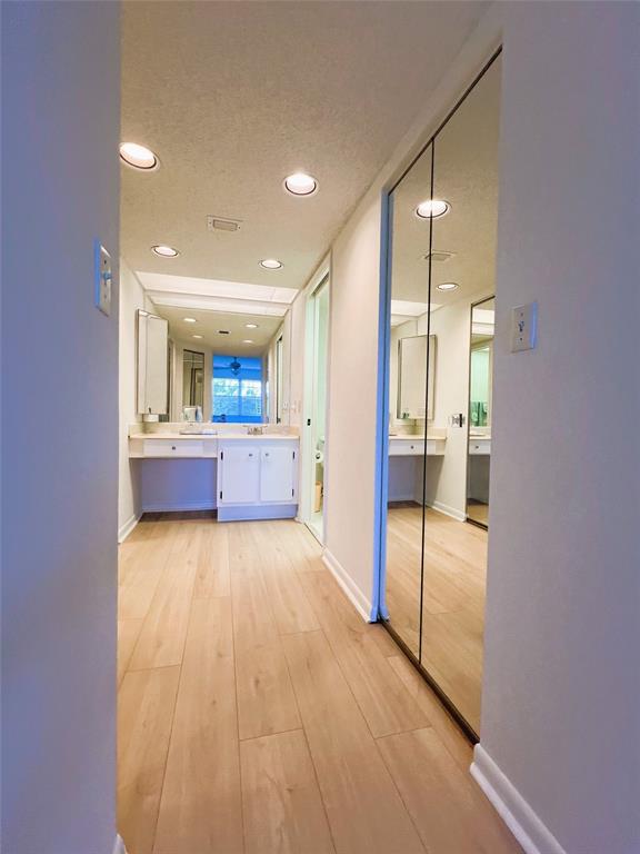 1803 Eleuthera Point, Unit J2 Coconut Creek, FL 33066 - Photo 8 of 27 a view of a hallway with wooden floor and a bathroom