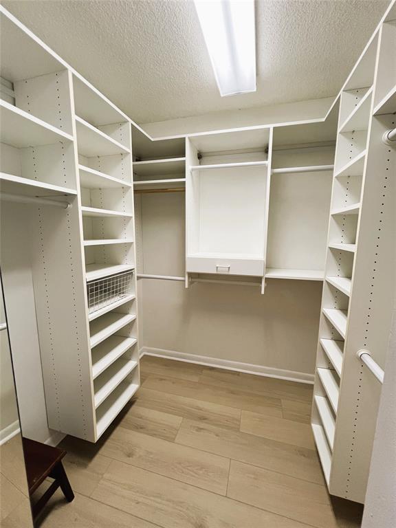1803 Eleuthera Point, Unit J2 Coconut Creek, FL 33066 - Photo 10 of 27 a view of walk in closet with empty racks