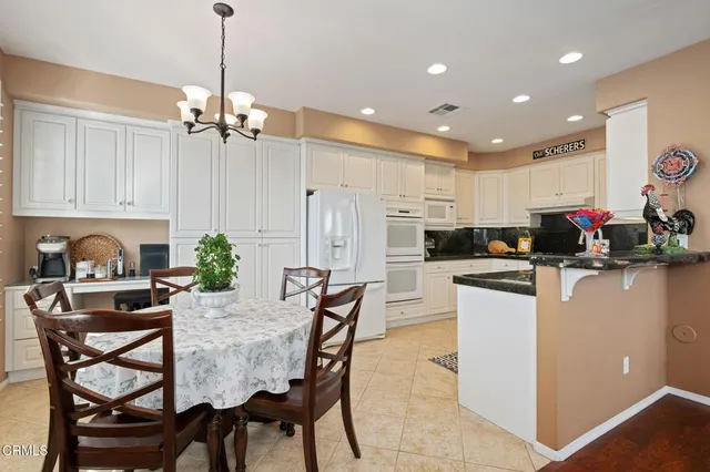 a kitchen with granite countertop a sink and cabinets
