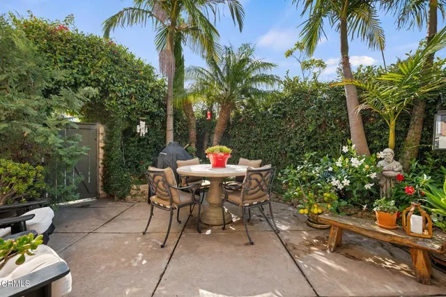 a view of outdoor dining space with a table and chairs in a patio