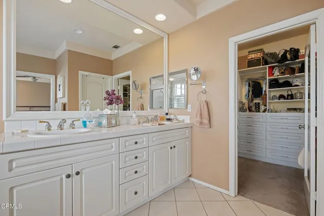 a bathroom with a granite countertop sink a toilet and shower