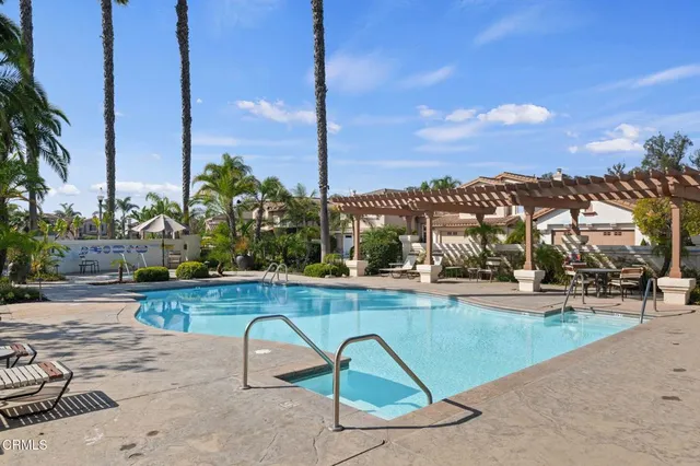 a view of a house with swimming pool and sitting area
