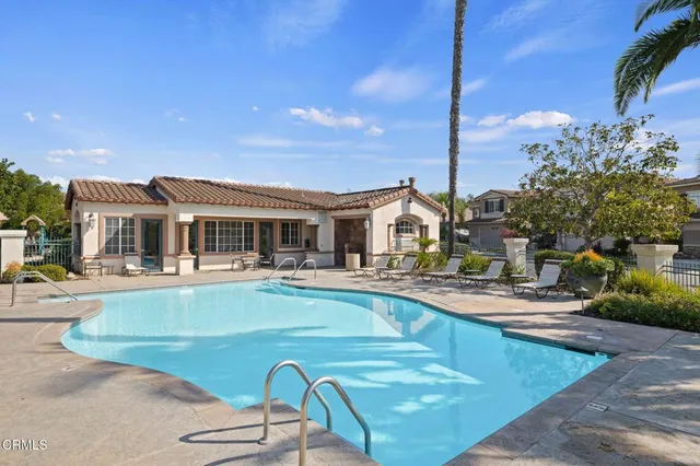 a view of a patio with table and chairs under an umbrella