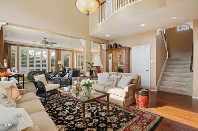 a living room with furniture and a chandelier