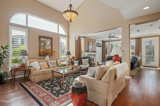 a living room with furniture and a chandelier
