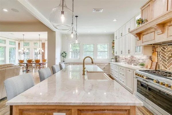 a kitchen with granite countertop a stove and a sink