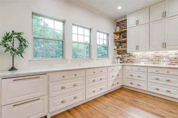 a kitchen with stainless steel appliances granite countertop a stove and a white cabinets