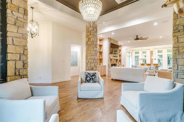 a living room with furniture a fireplace and a large window