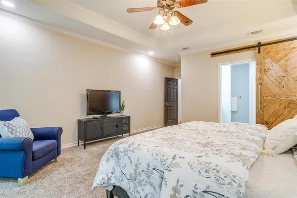 a bedroom with a bed couch and window