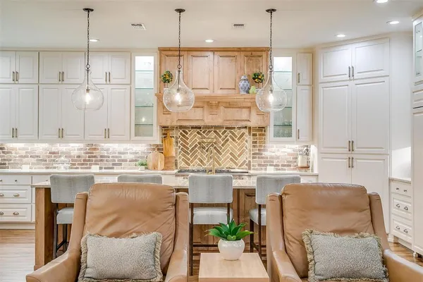 a kitchen with kitchen island granite countertop a table and chairs in it