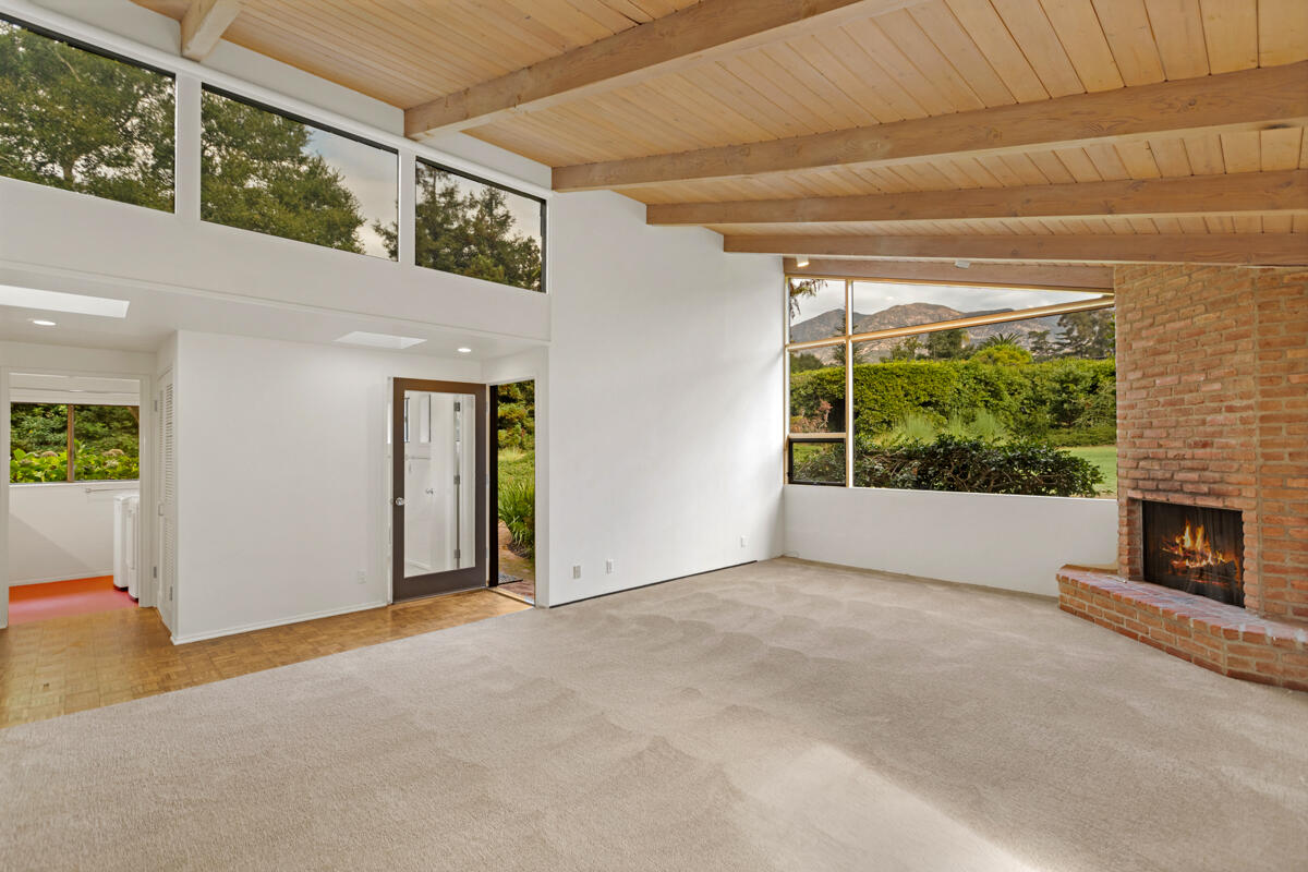 1681 East Valley Road Montecito, CA 93108 - Photo 24 of 61 a view of an empty room with a fireplace and a window