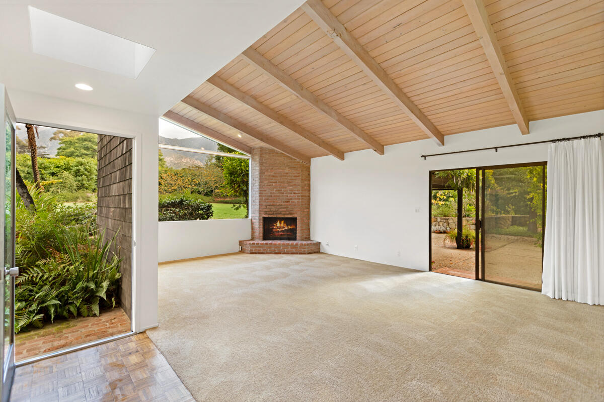 1681 East Valley Road Montecito, CA 93108 - Photo 25 of 61 a view of an empty room with a fireplace and a large window