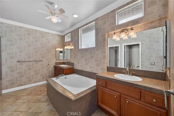 a bathroom with a tub sink and mirror