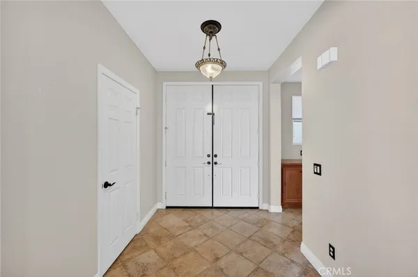 a view of a hallway with wooden floor and front door