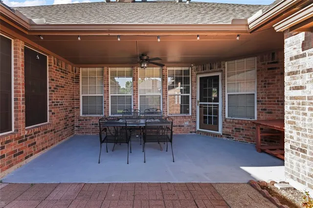 a patio with table and chairs
