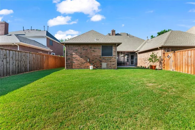 a view of a house with a yard and porch