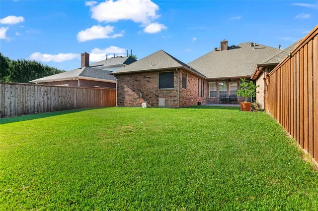 a view of a house with a yard and deck