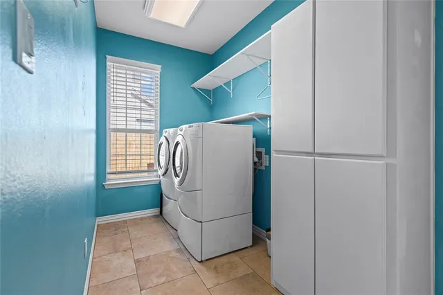 a room with a large window and a refrigerator