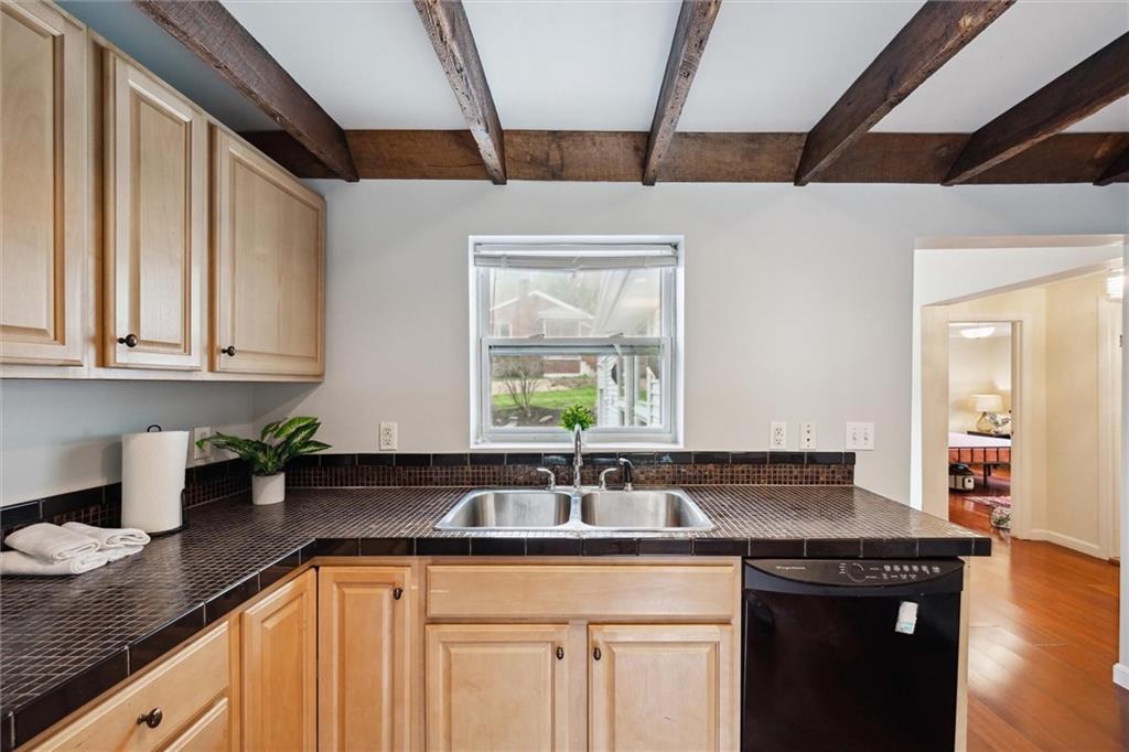 642 Filmore Road Pittsburgh, PA 15221 - Photo 8 of 30 a kitchen with stainless steel appliances granite countertop a sink a window and cabinets