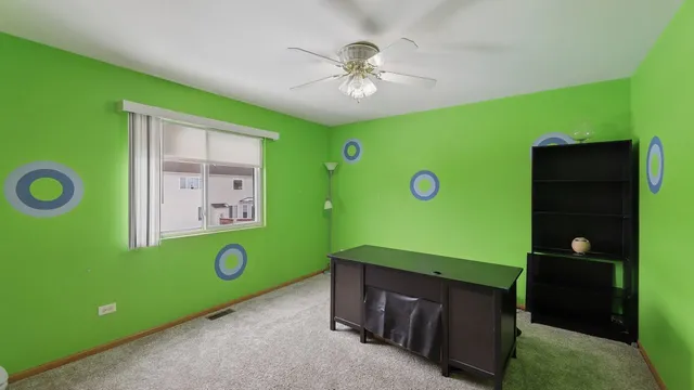 a room with pool table and a bookshelf