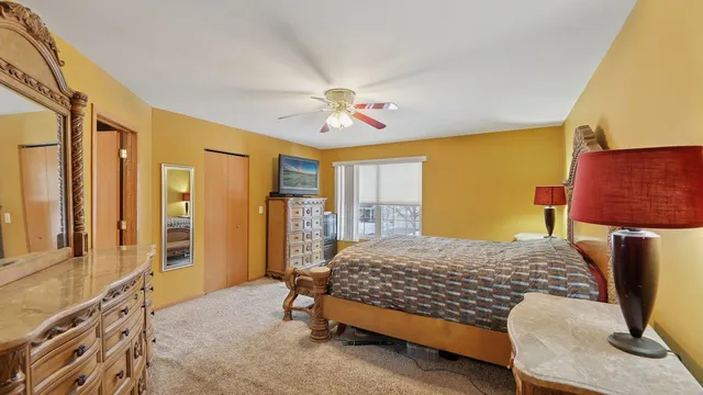 a bedroom with a bed dresser and a window