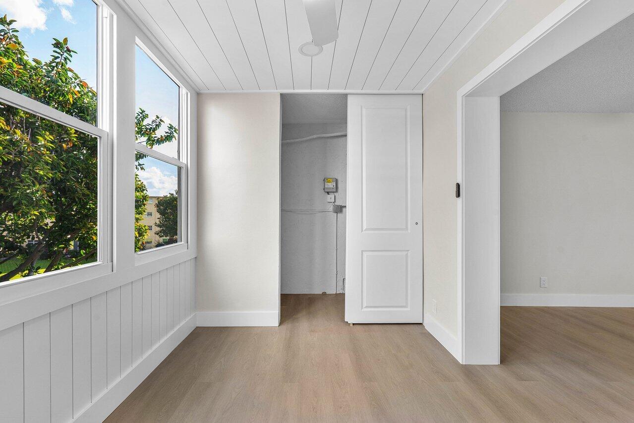 2601 Northeast 3rd Street, Unit 3040 Boynton Beach, FL 33435 - Photo 14 of 24 a view of an empty room with wooden floor and a window