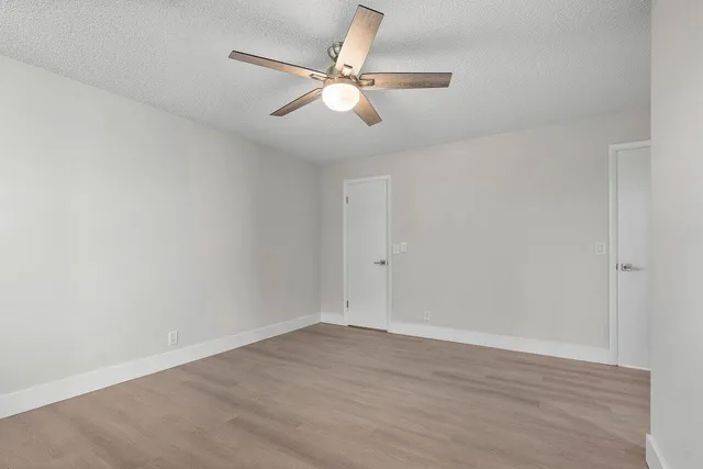 a view of an empty room with wooden floor