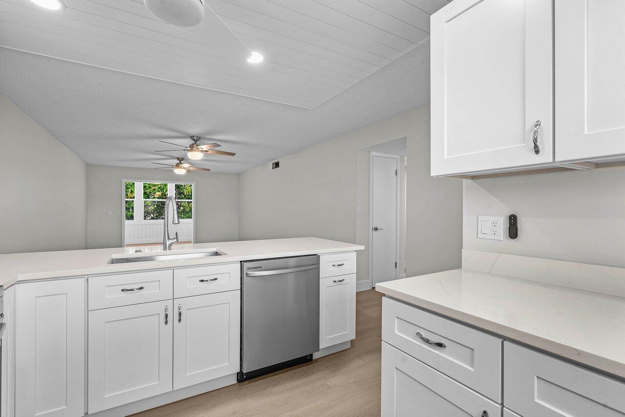 2601 Northeast 3rd Street, Unit 3040 Boynton Beach, FL 33435 - Photo 5 of 24 a utility room with cabinets washer and dryer