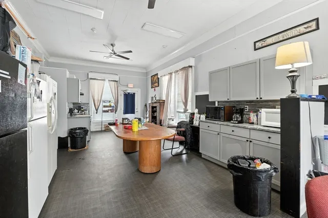 a kitchen with stainless steel appliances kitchen island granite countertop a refrigerator and a stove