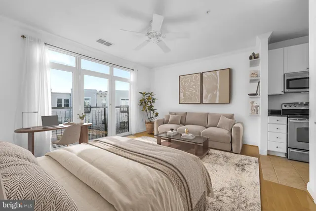 a bedroom with a large bed and a flat tv screen