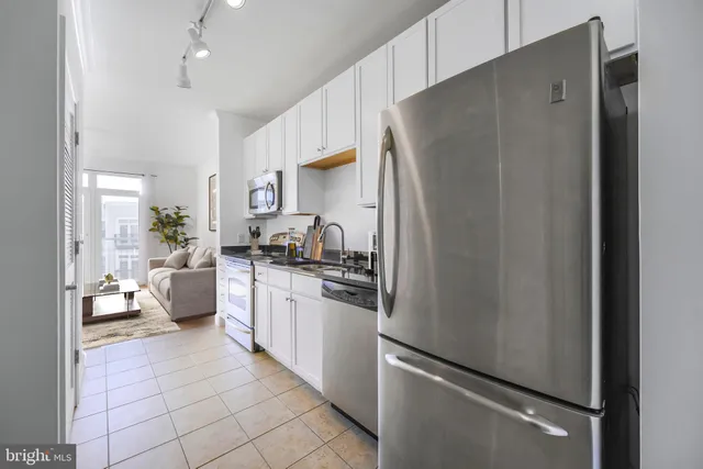 a kitchen with stainless steel appliances a refrigerator sink and stove
