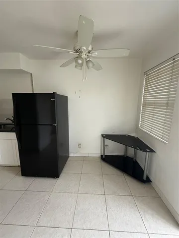 a room with a washing machine and a fireplace