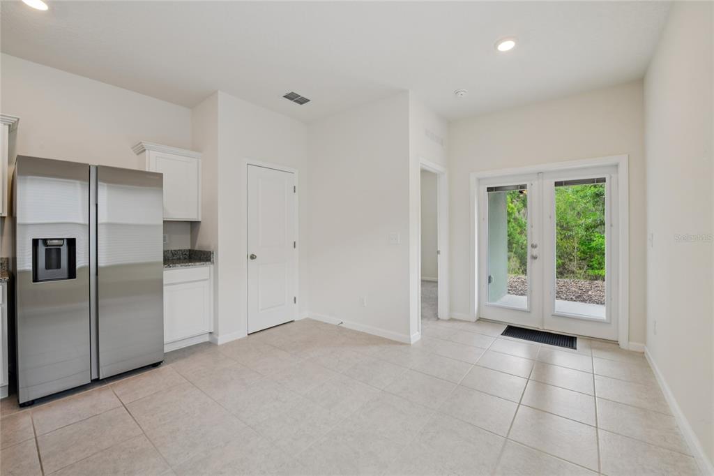 2352 Litchfield Loop DeLand, FL 32720 - Photo 11 of 24 a view of a kitchen with a refrigerator and window