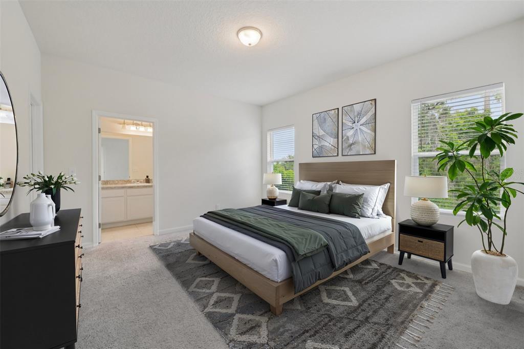 2352 Litchfield Loop DeLand, FL 32720 - Photo 12 of 24 a spacious bedroom with a bed and a potted plant