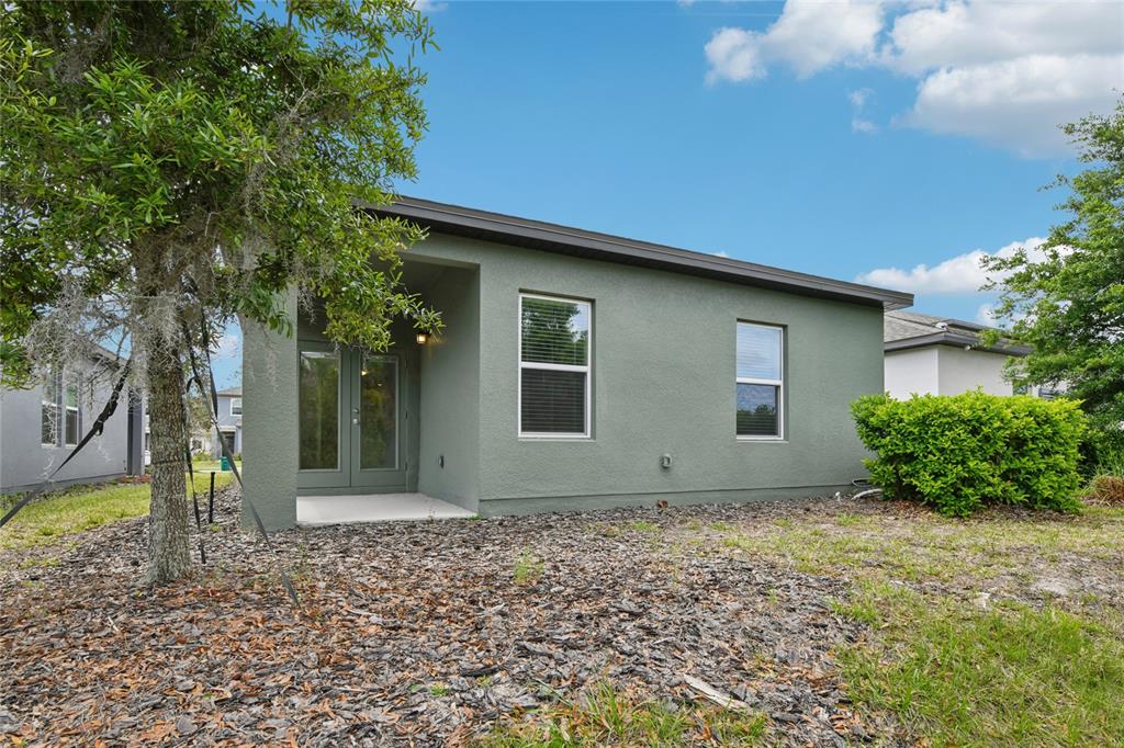 2352 Litchfield Loop DeLand, FL 32720 - Photo 20 of 24 a front view of a house with garden