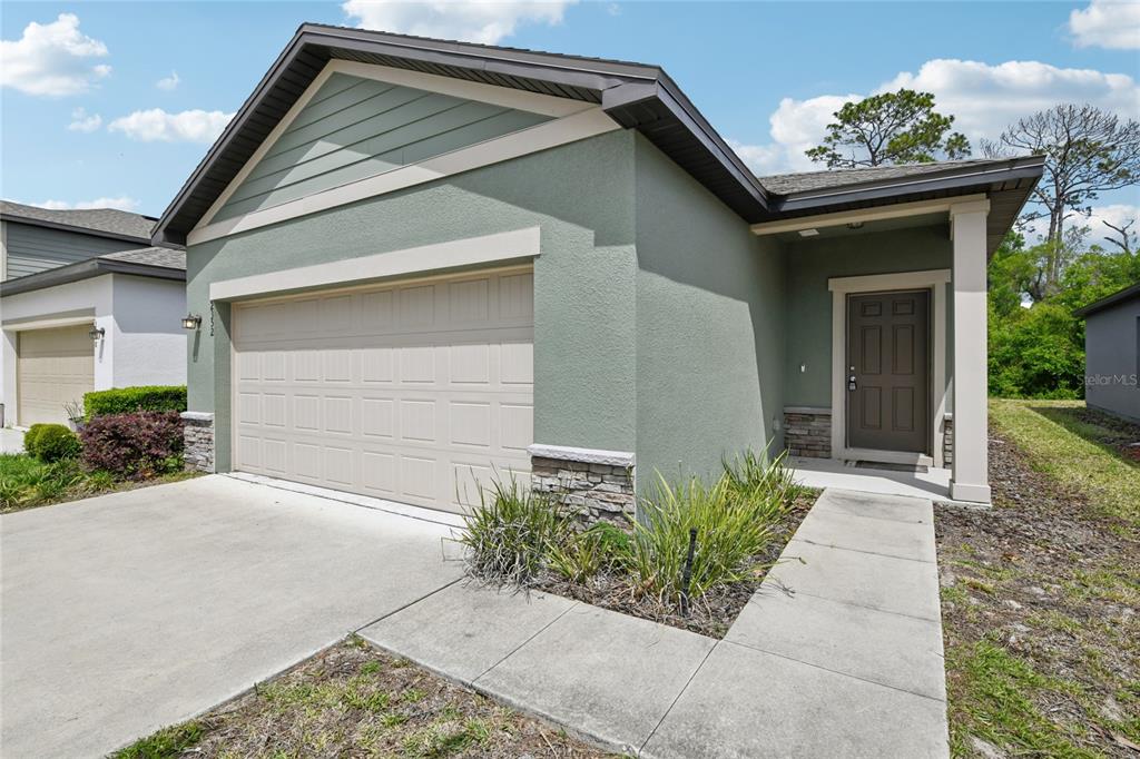 2352 Litchfield Loop DeLand, FL 32720 - Photo 2 of 24 a front view of a house with garden