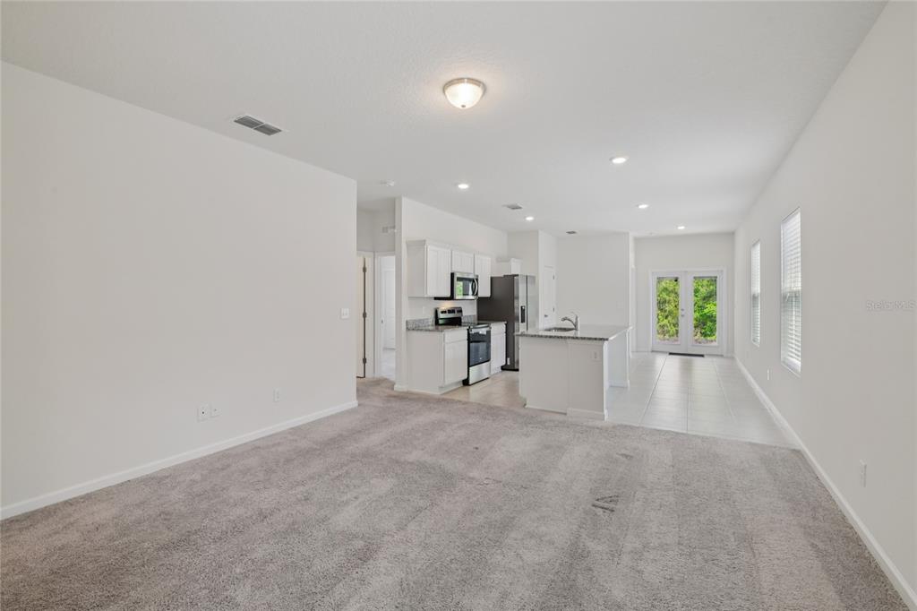 2352 Litchfield Loop DeLand, FL 32720 - Photo 5 of 24 a view of a kitchen with large windows