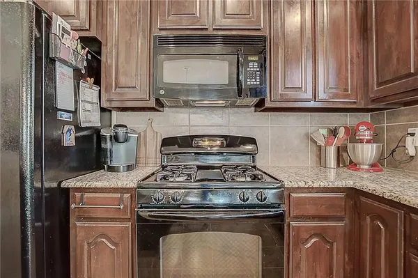a kitchen with stainless steel appliances granite countertop a stove and a microwave