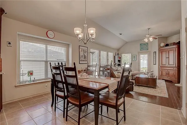 a view of a dining room with furniture and a chandelier