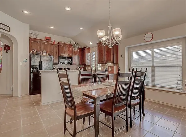 a view of a dining room with furniture and chandelier