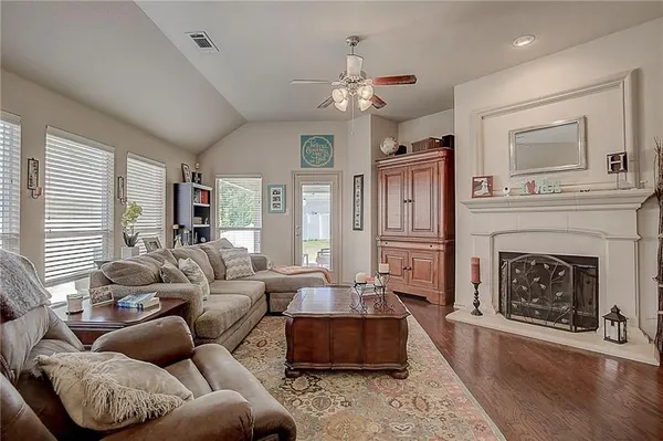a living room with furniture a fireplace and a window