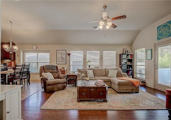 a living room with furniture and wooden floor
