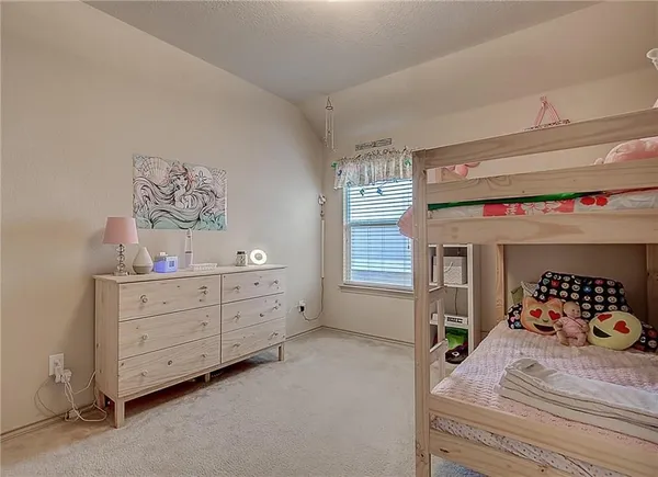 a bedroom with a bed and large windows