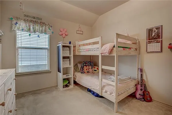 a bedroom with bed and a window