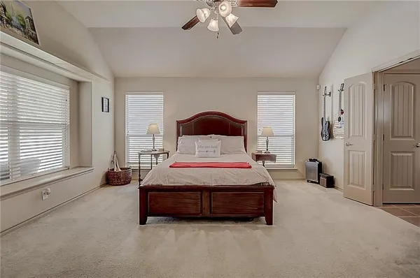 a spacious bedroom with a bed and window