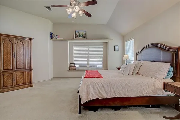 a bedroom with a bed and ceiling fan