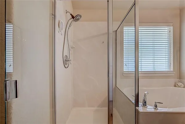 a bathroom with a bathtub with a shower