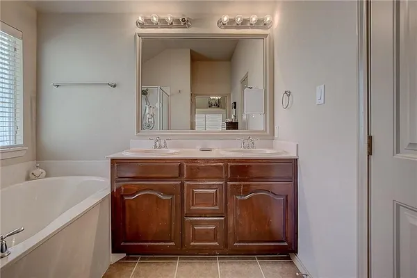 a bathroom with a sink vanity and mirror